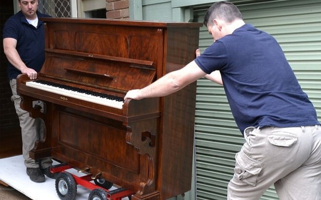 Upright piano strapped to a dolly for the carry