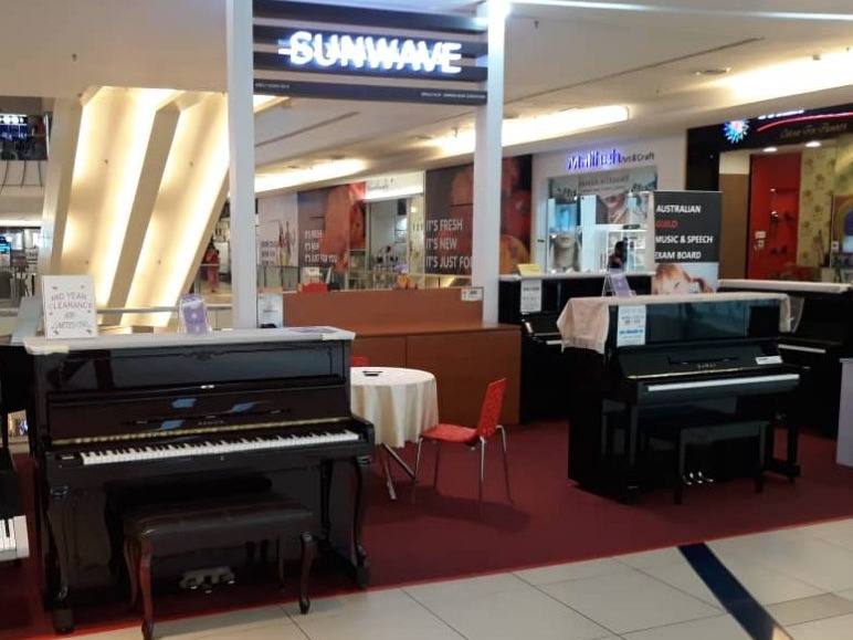 Sunwave piano shop in Malaysia with upright pianos on the floor
