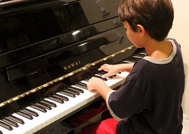 Child playing a rented upright piano at home