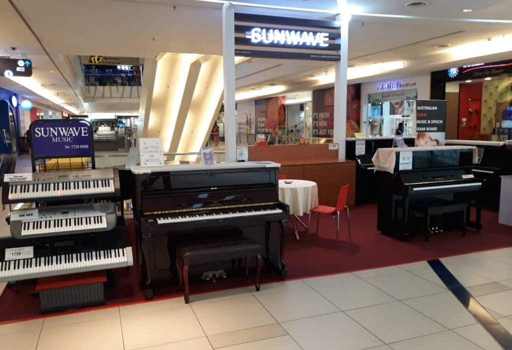 Piano shop floor at Tropicana City Mall with uprights and keyboards